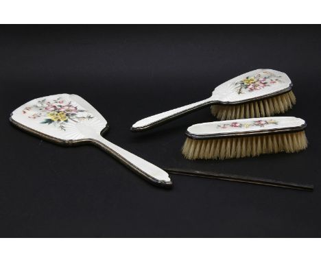 A Mappin & Webb silver and enamel brush set, the backs decorated with floral sprays