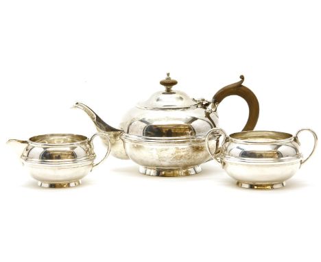 A silver three-piece tea service, Birmingham 1918, presentation inscription to base of teapot, approx 27cm gross