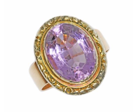 An antique amethyst ring, the oval mixed cut amethyst measuring approximately 16.48mm x 12.61mm, depth 8.42mm, ornate scroll 