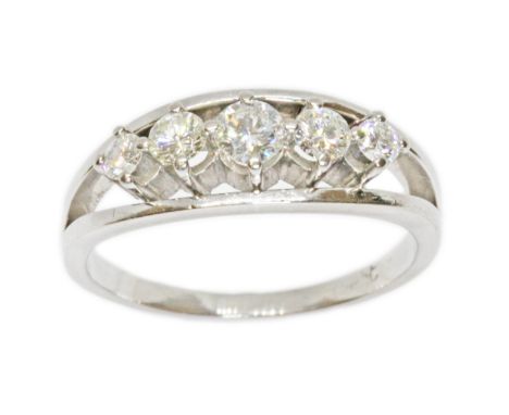 A five stone diamond ring, the round brilliant cut diamonds weighing approximately 0.65cts in total, white metal band indisti