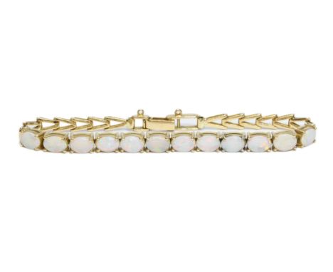 An Australian opal cabochon bracelet, marked 750 and AUST, length 19cm, gross weight 15.1g.Condition - missing a safety chain