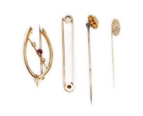 A mixed lot comprising a horseshoe brooch indistinctly marks, a hallmarked 9ct gold tie pin, a stick pin indistinctly marked 