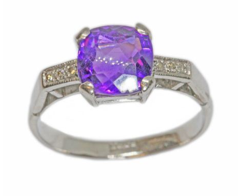 An amethyst and diamond ring, the central cushion cut stone measuring approximately 8mm x 8mm, depth 5.71mm, three single cut