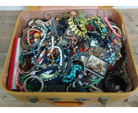 A vintage case contraining a large quantity of costume jewellery.