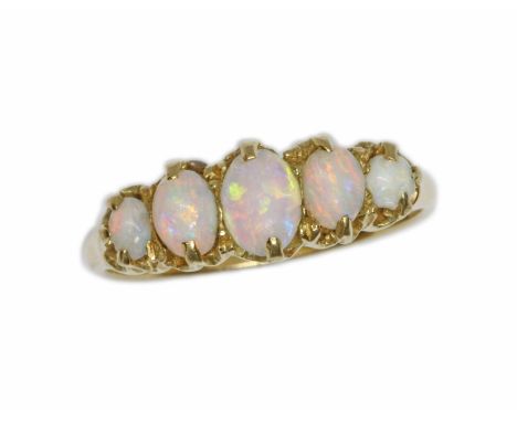 A FIVE STONE OPAL RING, the principal oval opal cabochon measuring approximately 6.30mm x 4.50mm, depth 2mm, band marked 18ct