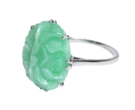 AN EARLY 20TH CENTURY ART DECO JADEITE JADE CABOCHON RING, the carved green jade cabochon measuring approximately 20mm x 16mm