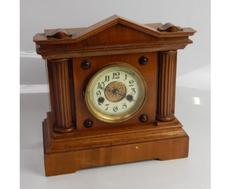 An eight day mantel clock, in architectural case with brass bezel and Arabic numerals, 30cm high.