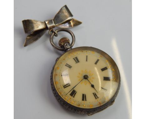 A silver fob watch, with top on white enamel dial, the gold motif, white metal marked 935.