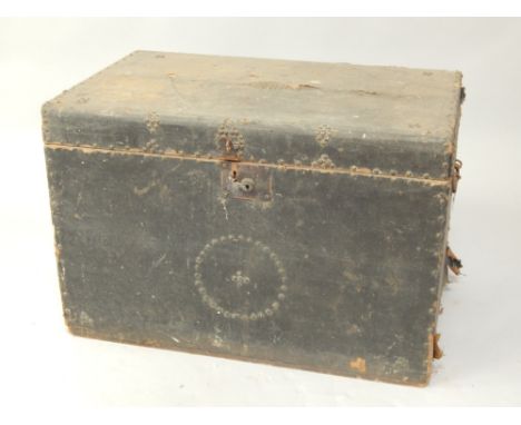 A 19thC trunk, with hinged lid and semi fitted interior, the exterior covered with brass studded American cloth.