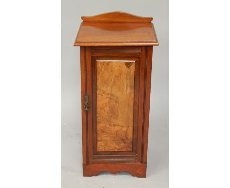 A late Victorian walnut pot cupboard, enclosed by a single fielded panel door.