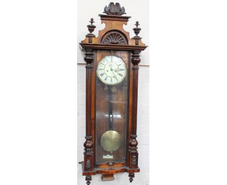 A late 19thC walnut Vienna wall clock, with enamel dial and 8 day movement, 120cm high.