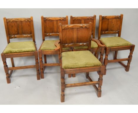 A set of five oak panel back dining chairs.