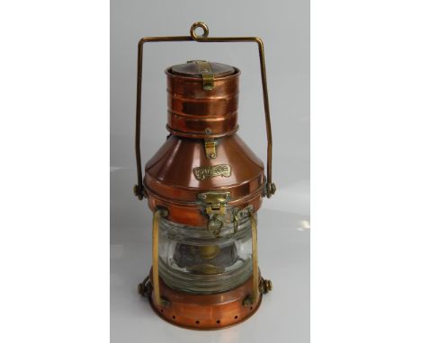 A copper and brass ships lantern, with brass plaque inscribed 'Anchor', and having integral oil burner, with swing handle,  3