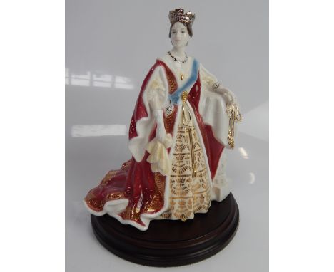 A Royal Worcester figure of Queen Victoria, 21.5cm high, with loose plinth base.