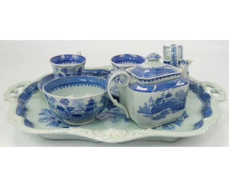 A Victorian blue and white ironstone tea service, comprising tray, together with two matched cups and saucers.