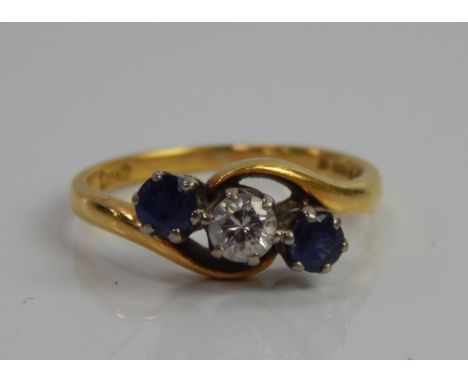 An 18ct gold dress ring, with three inset stones, two sapphires and one diamond, in twist setting, in platinum setting, on go