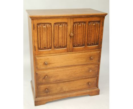An oak cupboard, enclosed by two linenfold panel doors and with three drawers below with turned knop handles, 84cm wide.