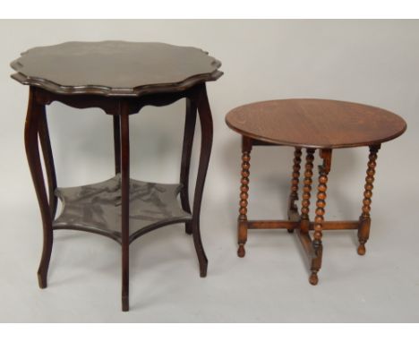 A early 20thC mahogany finished centre table, with shaped moulded circular top on stylised cabriole legs with undershelf, 59c