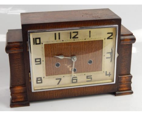 A 1930s eight day striking mantel clock, in an oak case with silvered chapter ring and Arabic numerals, 22cm high.