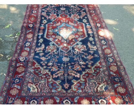 An Azary Iranian carpet, upon claret and blue ground, 260cm x 124cm. 