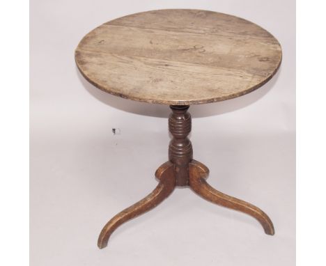 An 18thC circular tripod table, with a triple plank top supported on a turned and ring collared column and haunched scrolling