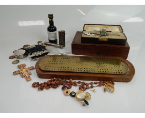 An oak and brass cribbage board, a drawing set case with fitted interior, a silver and enamelled spoon and a napkin christeni