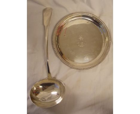 EPNS SERVING LADLE IN GEORGIAN STYLE - ENGRAVED WITH ARMORIAL CREST AND AN UNMARKED WHITE METAL WAITER TRAY, GADROONED EVERTE