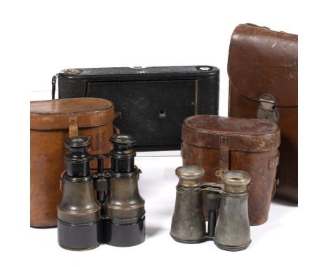 Pair of army binoculars in a leather case, another pair of binoculars in a leather case and a folding Kodak camera in a leath