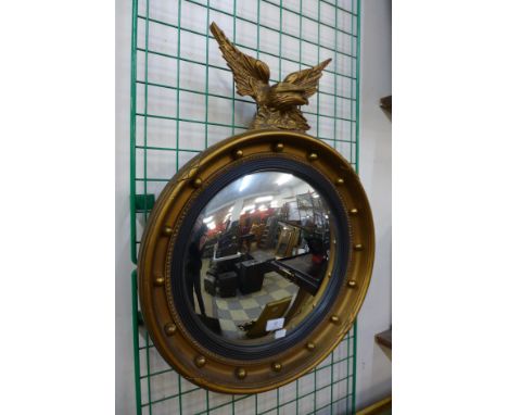 A Regency style gilt framed convex mirror, 66cms h 