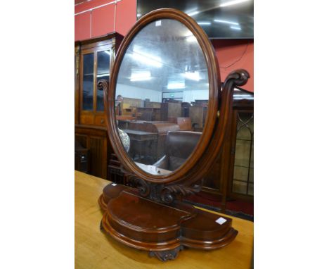 A Victorian mahogany toilet mirror, 84cms h 