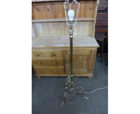 A brass tripod standard lamp 