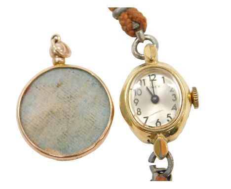 A circular rose metal double sided photo locket, stamped 375, 1.2g all in, together with a Timex ladies gold plated cased wri