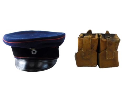 A replica WWI Imperial German Prussian artillery officer's peaked cap, dark blue wool with crimson piping, together with an u
