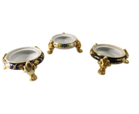 Three Noritake porcelain urn stands, each on three gilt feet.