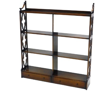 A mahogany wall shelf, in Chippendale style, with an arrangement of six shelves and two drawers, with trefoil pierced end sup