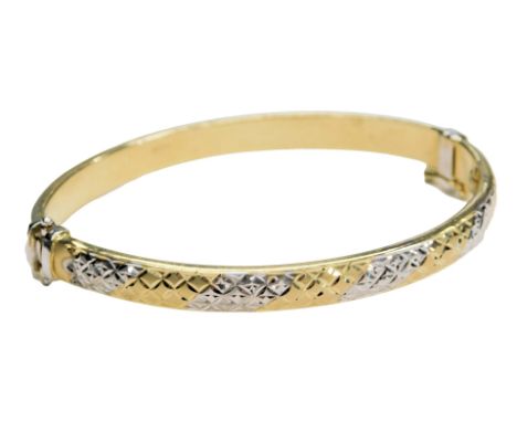 A two colour bangle, in a lattice design, on a snap clasp, stamped 14k, 9.1g.