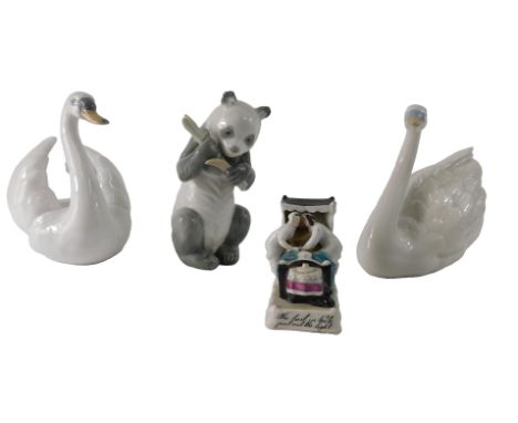 A Nao porcelain panda, a 19thC German fairing The Last in Bed Put Out The Light, and two porcelain swans.