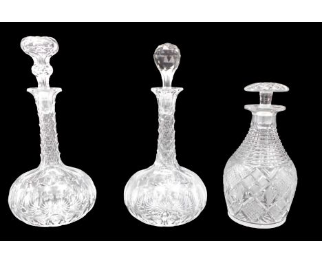 A pair of bottle shaped decanters, with associated stoppers, 30cm high, and a hobnail cut decanter, with mushroom stopper, 23