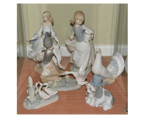 Three Lladro figures, together with two Nao groups, and other, tallest piece 25cm high  (6), 