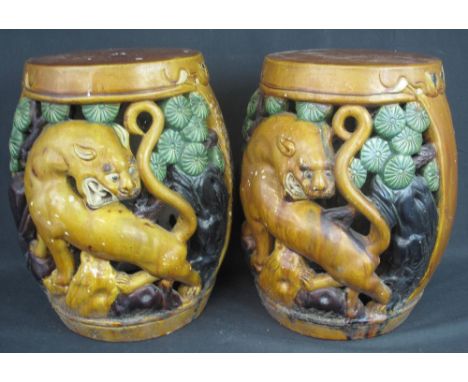 PAIR OF CHINESE STYLE PIERCED SANCAI GLAZED BARREL SHAPED POTTERY GARDEN SEATS with Lion Dog and foliate decoration. 38cm hig