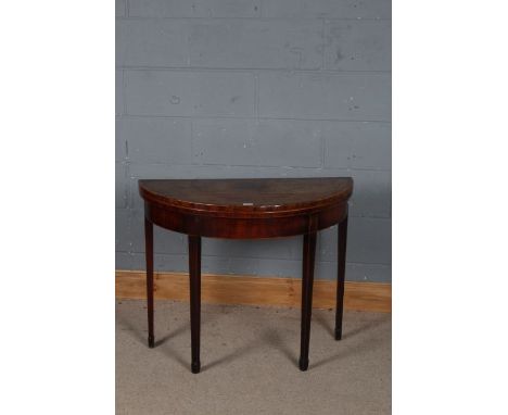 George III mahogany demi lune card table, the top decorated with cross banding, raised on tapering legs, 91cm wide 73cm high 