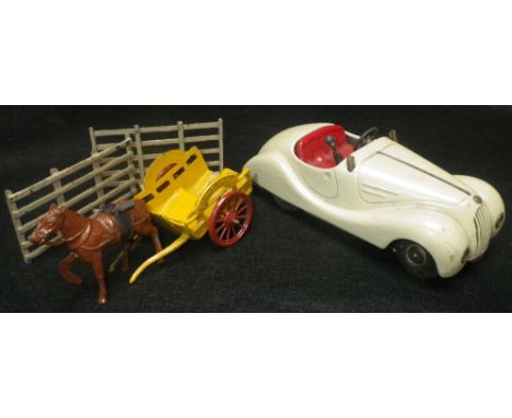 A SCHUCO 'EXAMIICO 4001' clockwork car in cream and a 'Mimic toy' white metal milk float with horse and two fences