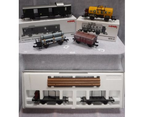 MARKLIN GAUGE 1:  A COLLECTION OF TRUCKS AND ROLLING STOCK including Gas Wagon, Oil Wagon, Timber Wagon and two others, Nos. 