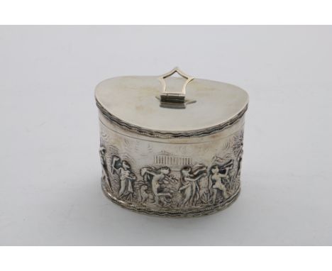AN EARLY 20TH CENTURY NAVETTE-SHAPED TEA CADDY with a curved top, swing finial and embossed figural decoration around the sid