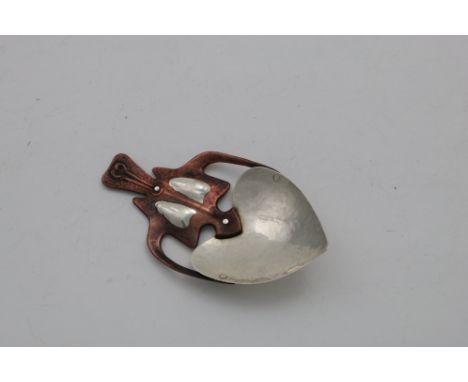 AN ART NOUVEAU, BI-METAL CADDY SPOON  with a hammered finnish, rivetted construction and a shaped &amp; pierced form, unmarke