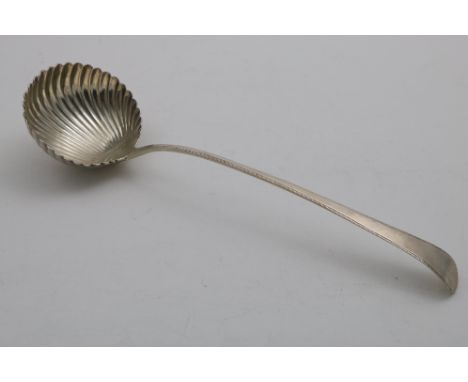 A GEORGE III FEATHER-EDGE SOUP LADLE with a swirl-fluted circular bowl, by Hester Bateman, London 1774;  13.5"  (34.3 cms) lo