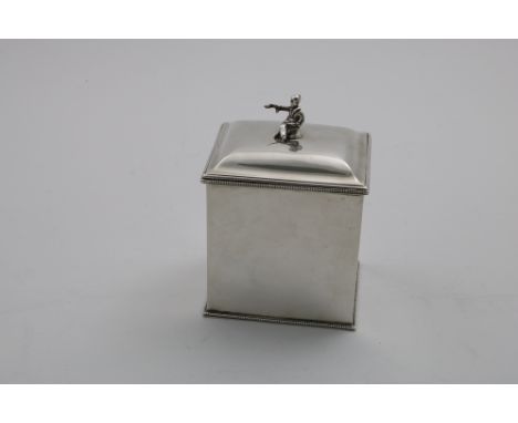 AN EARLY 20TH CENTURY RECTANGULAR TEA CADDY with bead borders, a domed cover and a seated chinaman-figure finial, the base wi
