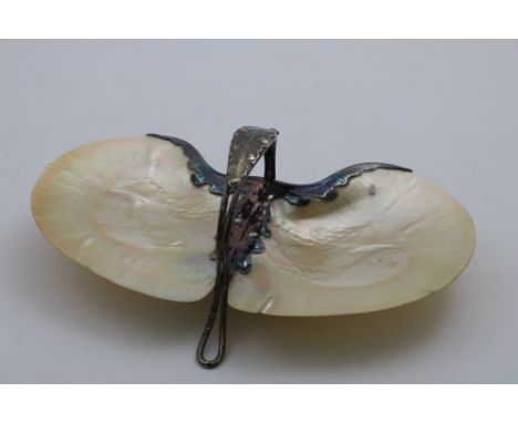 AN EDWARDIAN MOUNTED MOTHER-OF-PEARL SHELL DISH with a central handle, resembling a butterfly, wirework feet, by William Hutt
