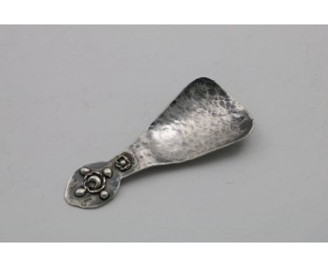 AN EARLY 20TH CENTURY SCOTTISH CADDY SPOON with a flaring, hammered bowl, the terminal with applied beads and corded wire, ma