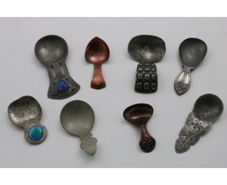 AN ART NOUVEAU PEWTER CADDY SPOON with a blue/green enamelled boss, by Liberty &amp; Co., another Liberty &amp; Co. pewter ca